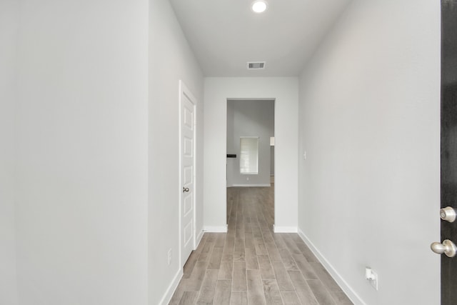 corridor with light hardwood / wood-style floors