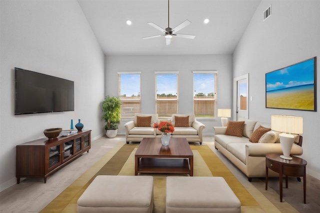 living room featuring high vaulted ceiling, light hardwood / wood-style flooring, and ceiling fan