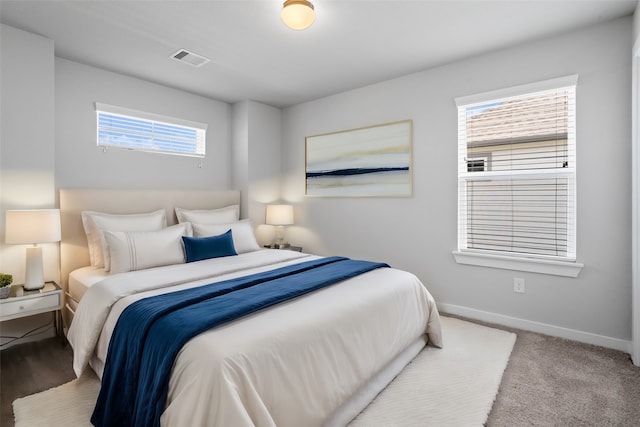 carpeted bedroom with multiple windows