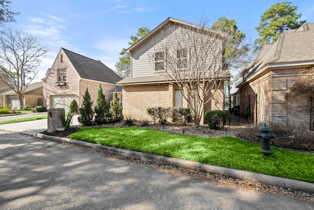 view of property with a front lawn and a garage