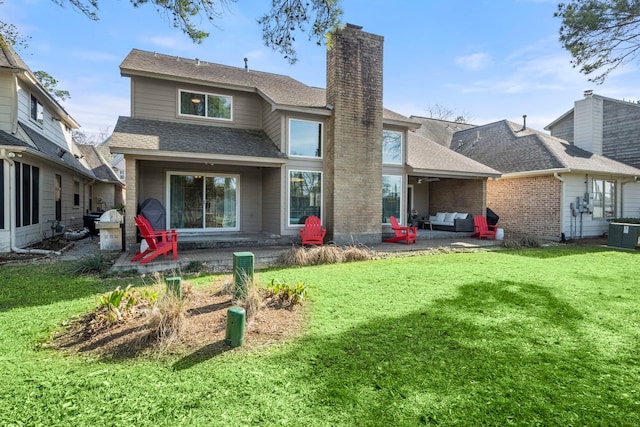 rear view of property featuring a patio, central AC, and a lawn