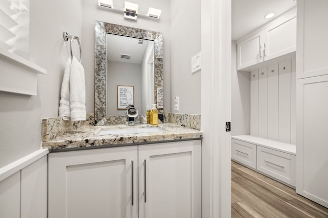 bathroom featuring vanity and wood-type flooring