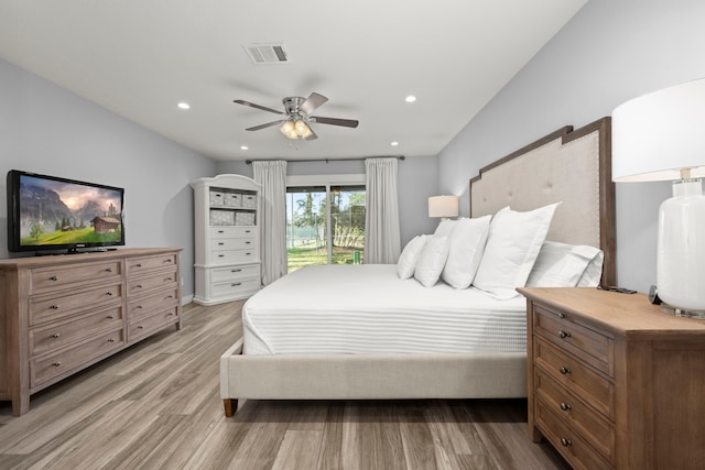 bedroom featuring ceiling fan, light hardwood / wood-style flooring, and access to exterior