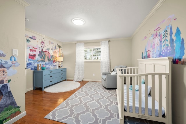 bedroom featuring crown molding, hardwood / wood-style floors, and a textured ceiling