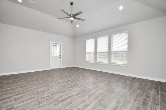 spare room featuring plenty of natural light, ceiling fan, and light wood-type flooring