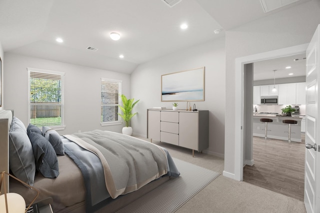 bedroom featuring vaulted ceiling and light wood-type flooring