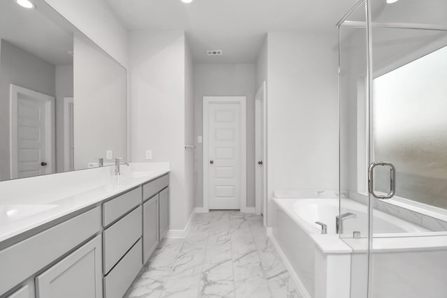 bathroom with vanity and independent shower and bath