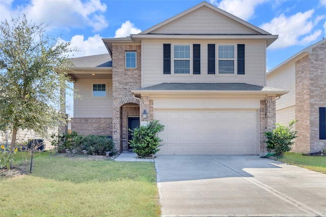 front facade featuring a front yard and a garage