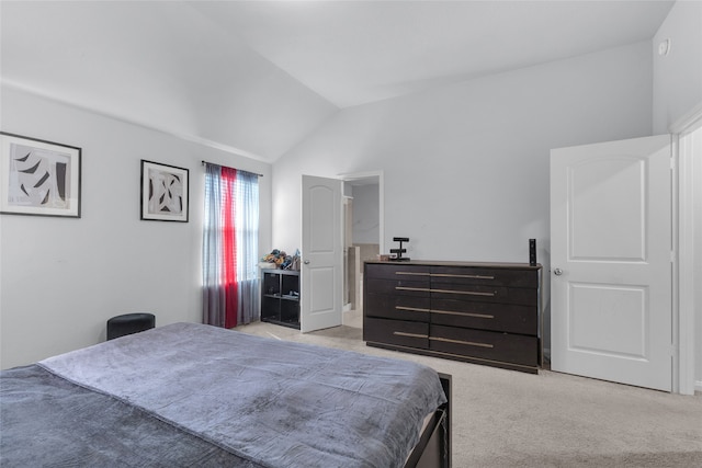 bedroom with light colored carpet and vaulted ceiling