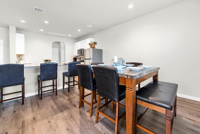 dining space featuring light wood-type flooring