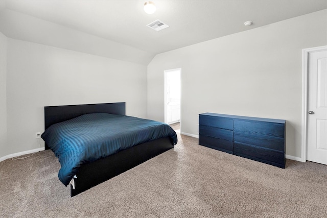 carpeted bedroom with lofted ceiling