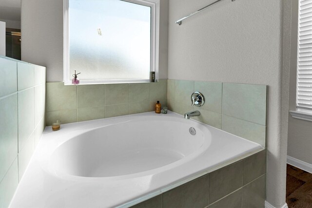 bathroom with tiled bath