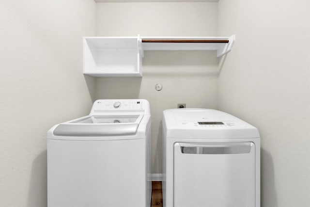 clothes washing area with washing machine and clothes dryer