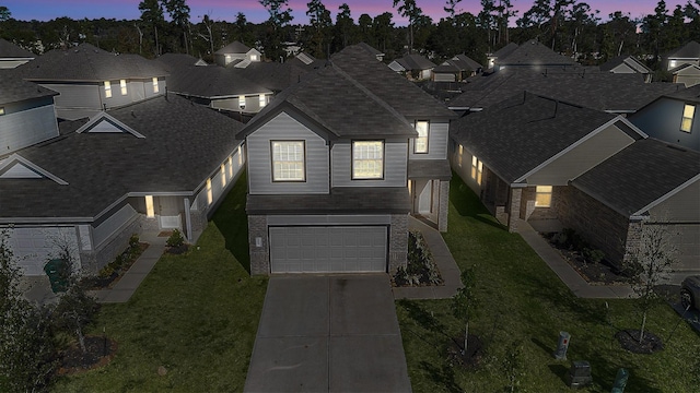 view of front of home featuring a yard and a garage