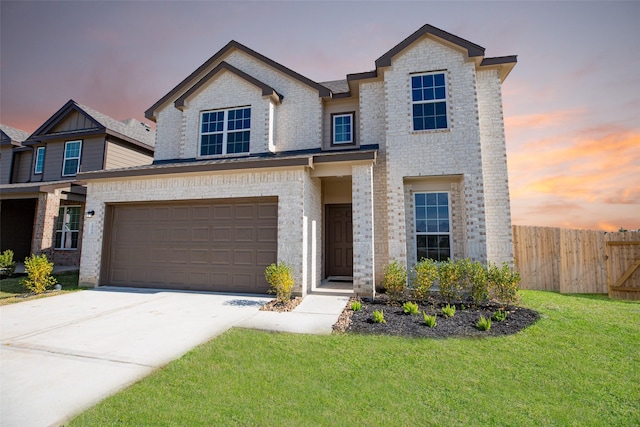 view of front of house featuring a garage and a yard