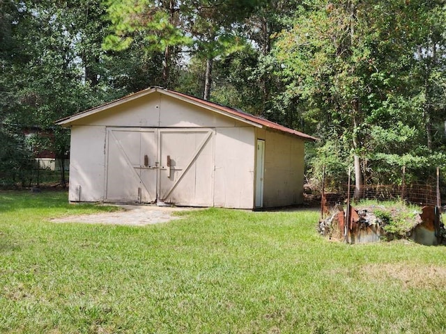 view of outbuilding featuring a yard