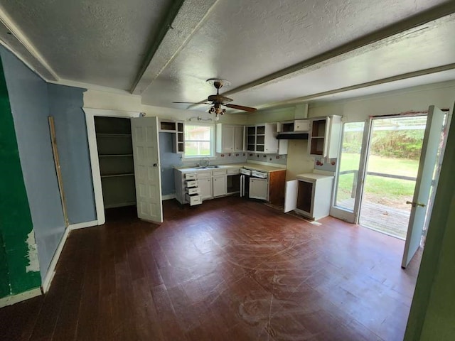 kitchen with white cabinets, ceiling fan, a textured ceiling, beamed ceiling, and dark wood-type flooring