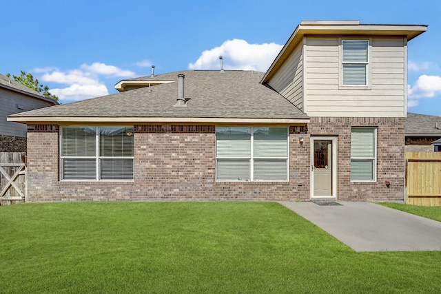 rear view of property featuring a patio and a yard