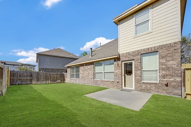 rear view of house with a patio area and a lawn