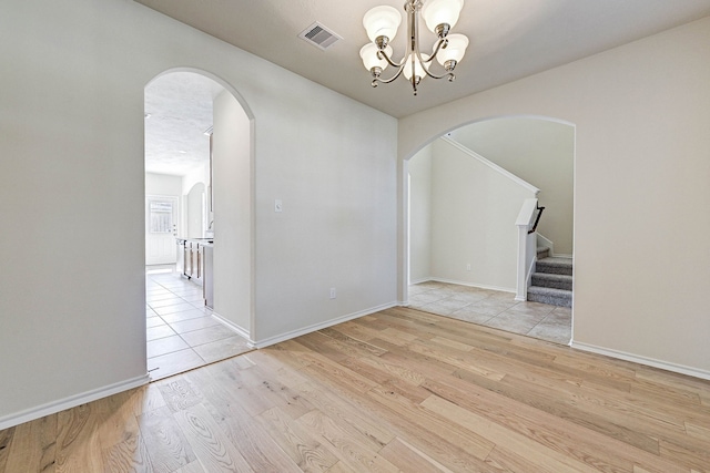 interior space with light hardwood / wood-style floors and a notable chandelier