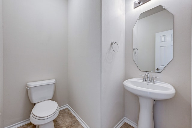 bathroom featuring toilet and tile patterned floors