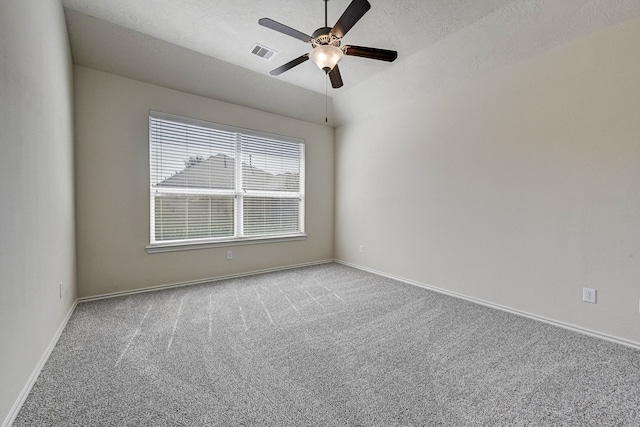 carpeted empty room with a textured ceiling and ceiling fan