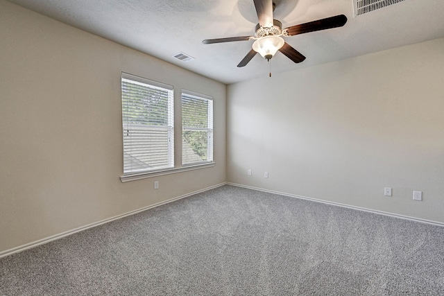 carpeted empty room featuring a textured ceiling and ceiling fan