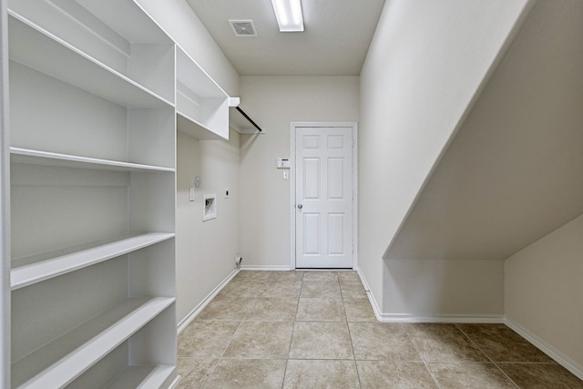 laundry room featuring gas dryer hookup, hookup for an electric dryer, hookup for a washing machine, and light tile patterned floors