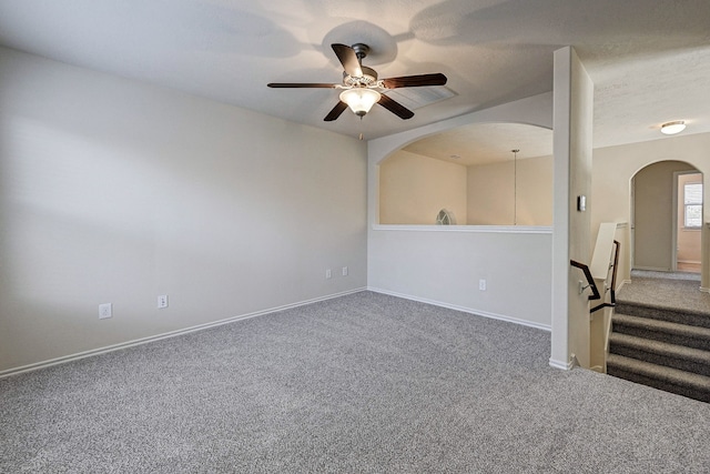 carpeted spare room with ceiling fan