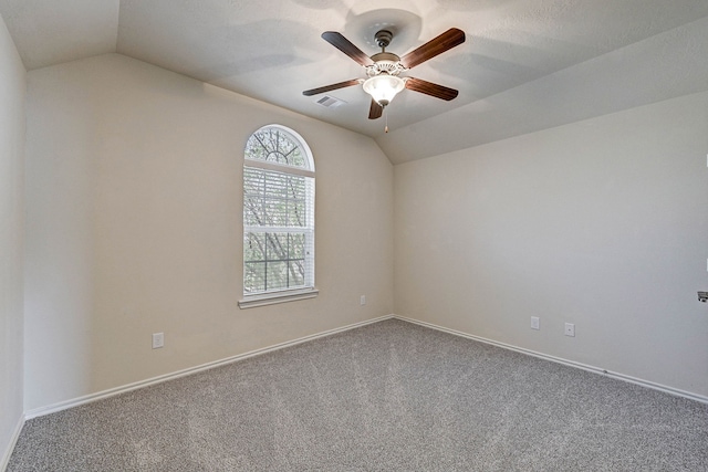 unfurnished room featuring lofted ceiling, carpet flooring, and ceiling fan