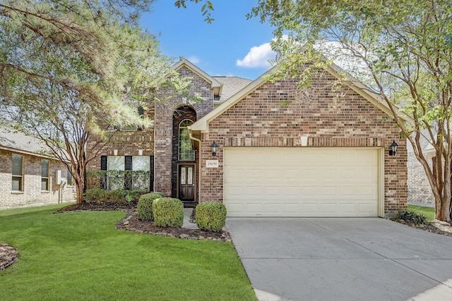 view of front property featuring a garage and a front lawn