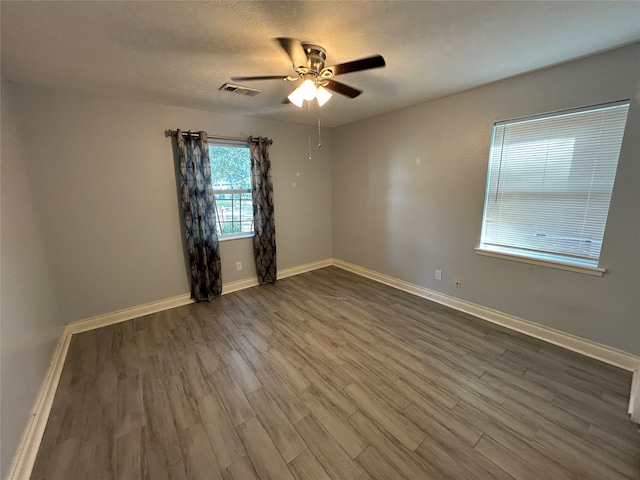 unfurnished room with a textured ceiling, hardwood / wood-style flooring, and ceiling fan