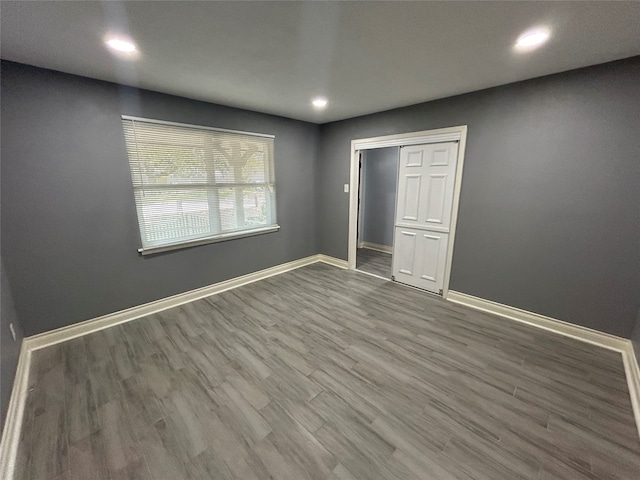 unfurnished bedroom with hardwood / wood-style floors and a closet