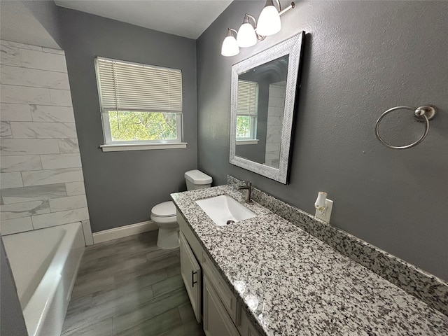 full bathroom with wood-type flooring, vanity, bathing tub / shower combination, and toilet