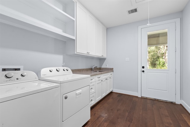 laundry room featuring washer and clothes dryer, sink, cabinets, and dark hardwood / wood-style floors