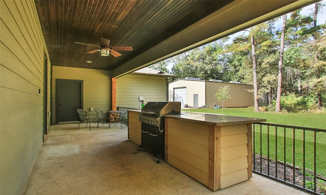 view of patio with area for grilling, ceiling fan, and an outdoor kitchen