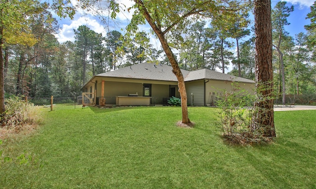 rear view of property with a lawn