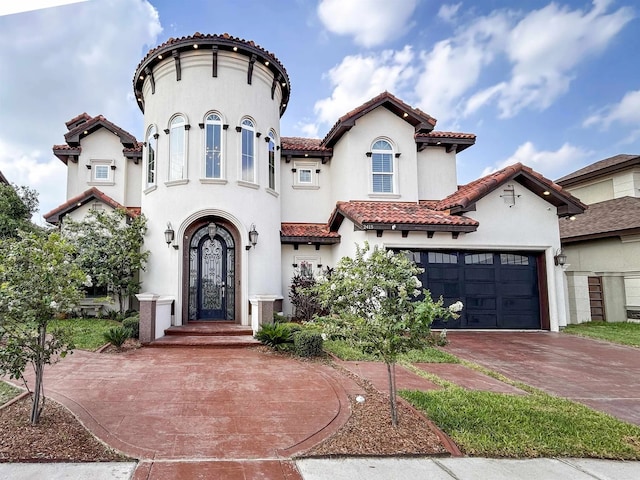 mediterranean / spanish-style house with a garage