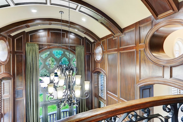 room details with an inviting chandelier and wooden walls