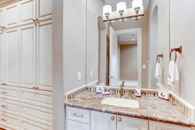 bathroom with vanity and crown molding