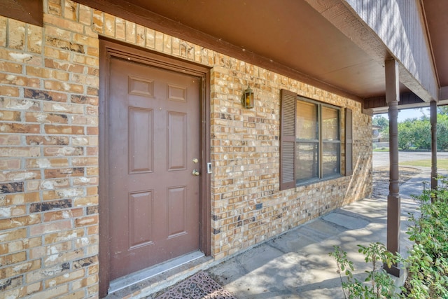 view of exterior entry with a porch