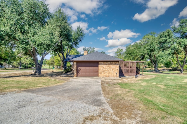 view of side of home with a garage and a yard