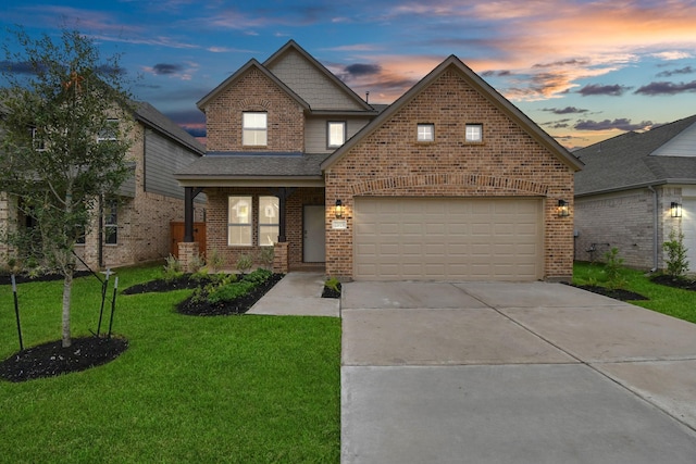view of front of house featuring a yard, brick siding, a shingled roof, driveway, and an attached garage