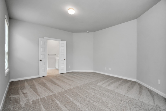 empty room featuring light colored carpet