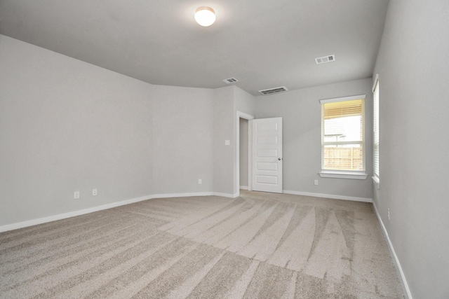 interior space with baseboards, visible vents, and carpet