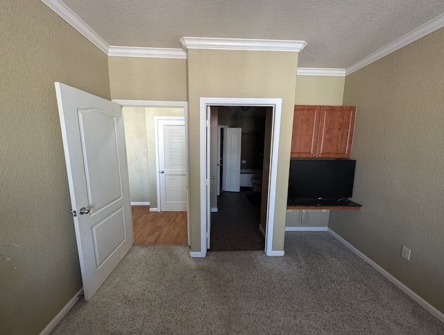 unfurnished bedroom with crown molding and carpet flooring