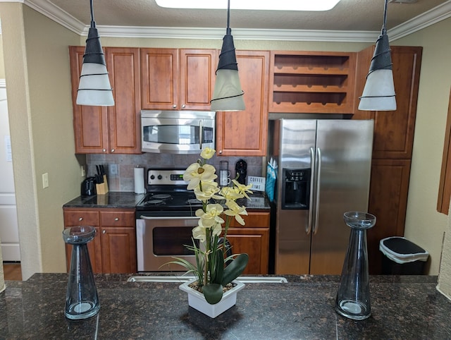 kitchen featuring ornamental molding, hanging light fixtures, stainless steel appliances, and backsplash