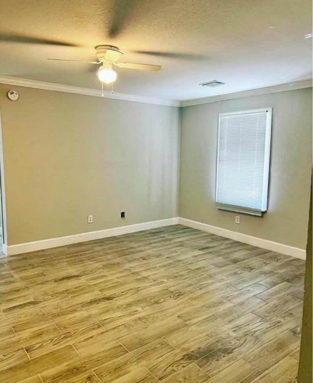 unfurnished room with ceiling fan, crown molding, and light hardwood / wood-style flooring