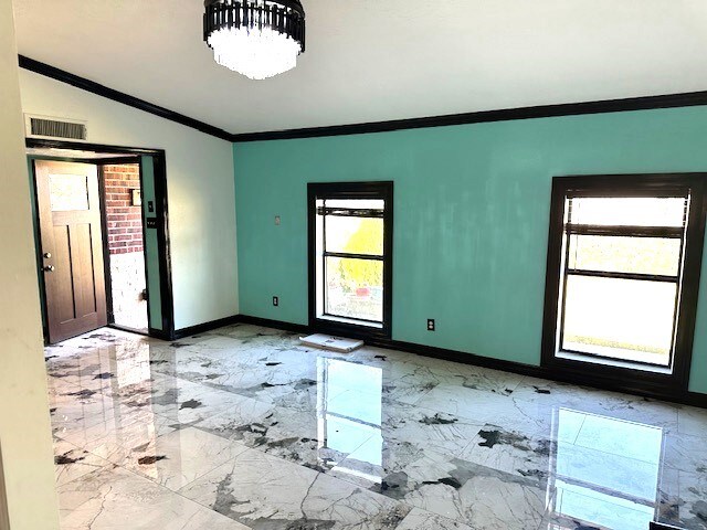 unfurnished room featuring ornamental molding