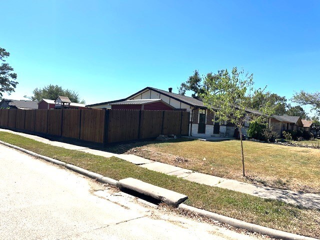 view of property exterior featuring a lawn